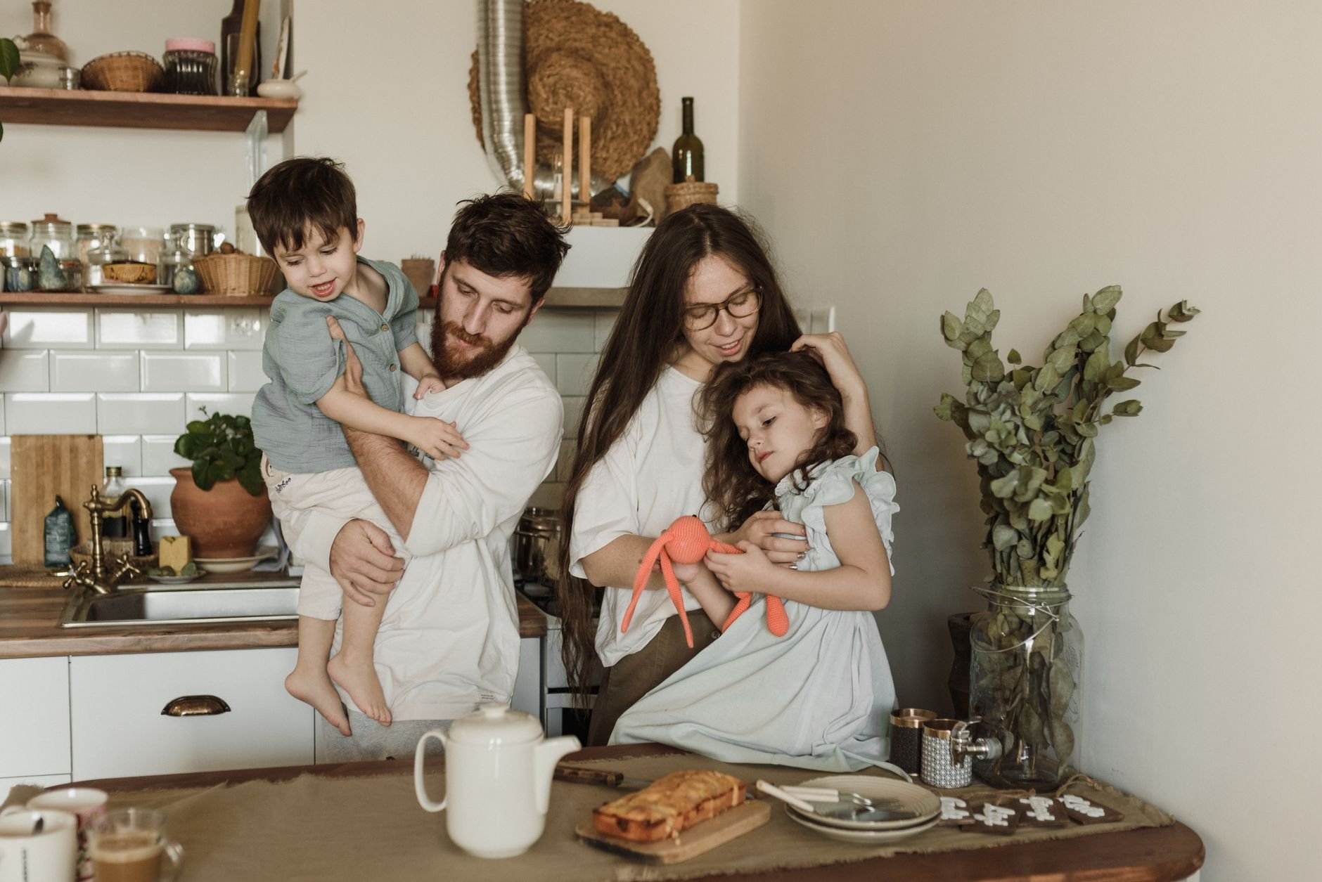 Happy family of four bonding in a warm and cozy kitchen setting, enjoying quality time together